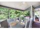 An outdoor screened porch with plenty of natural light, a dining table, and chairs at 5418 Amity Dr, Powder Springs, GA 30127