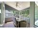 Screened-in porch with a dining table and chairs, perfect for outdoor entertaining at 5418 Amity Dr, Powder Springs, GA 30127