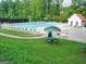 Community swimming pool with ample seating, picnic tables, and a nearby bath house at 5418 Amity Dr, Powder Springs, GA 30127