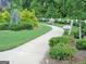 Paved walking path with benches, landscaping, and a white picket fence at 5418 Amity Dr, Powder Springs, GA 30127