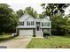 Charming two-story home with stone accents, white siding, black shutters, and well-maintained landscaping at 7030 Wessex Way, Cumming, GA 30028