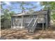 Exterior back of home featuring back porch with stairs, and tree coverage at 2106 Singer Way, Lithonia, GA 30058