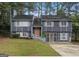 Charming split-level home with gray siding and a well-manicured front yard at 2106 Singer Way, Lithonia, GA 30058