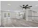 Spacious living room featuring a large ceiling fan and lots of natural light, open to kitchen at 2106 Singer Way, Lithonia, GA 30058