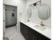 Bathroom featuring double sinks, modern hardware, and glass enclosed shower at 243 Roxbury Dr, Riverdale, GA 30274