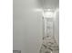 Hallway with tile flooring, light walls, and view into other rooms of the house at 243 Roxbury Dr, Riverdale, GA 30274