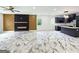 Open-concept living room with fireplace, dark cabinetry, and modern lighting at 243 Roxbury Dr, Riverdale, GA 30274