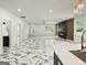 Open-concept living room with marble floors, fireplace, and views into the kitchen at 243 Roxbury Dr, Riverdale, GA 30274