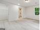 Bright bedroom featuring modern flooring, fresh paint, closet, and ensuite bathroom at 4451 Flat Shoals, Decatur, GA 30034