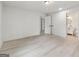 Bright bedroom featuring modern flooring, fresh paint, and access to ensuite bathroom at 4451 Flat Shoals, Decatur, GA 30034