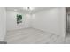 Bright bedroom with wood-look flooring, a large window, and ample natural light at 4451 Flat Shoals, Decatur, GA 30034