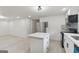 Open concept kitchen with an island, stainless steel refrigerator and modern appliances overlooks the living area at 4451 Flat Shoals, Decatur, GA 30034