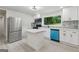 Bright kitchen features white cabinets, stainless steel appliances, an island, and a view of lush greenery outside at 4451 Flat Shoals, Decatur, GA 30034
