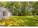 Spacious backyard showcasing a lush green lawn and a serene wooded backdrop at 6200 Beaver Creek Trl, Atlanta, GA 30349