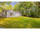 Backyard featuring an expansive lawn and mature trees for privacy and shade at 6200 Beaver Creek Trl, Atlanta, GA 30349