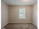 Bright bedroom with carpet and a window offering natural light and a view at 6200 Beaver Creek Trl, Atlanta, GA 30349