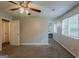 Spacious bedroom featuring plush carpet, a ceiling fan, and ample natural light from large windows at 6200 Beaver Creek Trl, Atlanta, GA 30349
