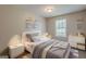 Cozy bedroom with plush carpet, white furniture, and natural light from the window at 6200 Beaver Creek Trl, Atlanta, GA 30349
