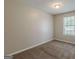 Neutral bedroom featuring carpet, a ceiling light, and a window with a view at 6200 Beaver Creek Trl, Atlanta, GA 30349