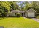 Charming one-story home with a well-manicured lawn and mature trees at 6200 Beaver Creek Trl, Atlanta, GA 30349