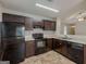 Efficient kitchen featuring dark cabinets, black appliances and ample counter space at 6200 Beaver Creek Trl, Atlanta, GA 30349