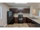 Functional kitchen with black appliances, wooden cabinets, and ample counter space at 6200 Beaver Creek Trl, Atlanta, GA 30349