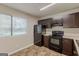 Functional kitchen with black appliances, wooden cabinets, and ample counter space at 6200 Beaver Creek Trl, Atlanta, GA 30349