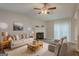 Cozy living room featuring a fireplace, plush seating, and lots of natural light at 6200 Beaver Creek Trl, Atlanta, GA 30349