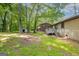 The backyard features a wooden deck and storage shed, surrounded by mature trees and ample green space at 1105 Buckhurst Dr, Atlanta, GA 30349