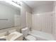 Bathroom with a vanity, toilet, bathtub, and shower combo with tiled walls at 1105 Buckhurst Dr, Atlanta, GA 30349