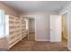 Bedroom with sliding closet, carpet, and built in shelving and adjoined bathroom at 1105 Buckhurst Dr, Atlanta, GA 30349