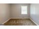 Empty bedroom with neutral paint, carpet flooring, and a window at 1105 Buckhurst Dr, Atlanta, GA 30349