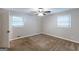 Bedroom featuring two windows, neutral paint, a ceiling fan, and carpeted flooring at 1105 Buckhurst Dr, Atlanta, GA 30349