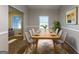 Formal dining room with a large wooden table, seating for eight, and bright natural light at 1105 Buckhurst Dr, Atlanta, GA 30349