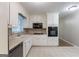 Bright kitchen with white cabinetry and stainless steel microwave, offering ample countertop space at 1105 Buckhurst Dr, Atlanta, GA 30349