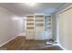 Spacious living room featuring carpet flooring and built-in shelving units with cabinets at 1105 Buckhurst Dr, Atlanta, GA 30349