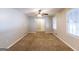 Spacious living room with carpet, ceiling fan, and natural light from two large windows at 1105 Buckhurst Dr, Atlanta, GA 30349