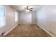Bright living room with carpet, ceiling fan, and natural light from a large window at 1105 Buckhurst Dr, Atlanta, GA 30349