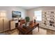 Well-lit home office featuring a large desk, comfortable chair, and ample storage shelves at 1105 Buckhurst Dr, Atlanta, GA 30349