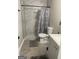 Updated bathroom with marble tiled shower, modern vanity, and a grey tiled floor at 176 Avalon Way, Riverdale, GA 30274