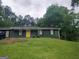 Charming single-story home with a bright yellow door and a well-maintained front lawn at 176 Avalon Way, Riverdale, GA 30274