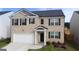 Charming two-story home featuring a brick facade, well-manicured lawn, and a two-car garage, perfect for families at 2159 Redfern, Dacula, GA 30019