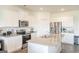 Bright kitchen featuring white cabinets, granite countertops, stainless steel appliances, and a spacious island at 2159 Redfern, Dacula, GA 30019