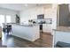 Bright kitchen featuring white cabinets, granite countertops, stainless steel appliances, and a spacious island at 2159 Redfern, Dacula, GA 30019