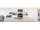 Bright kitchen featuring white cabinets, granite countertops, stainless steel appliances, and a spacious island at 2159 Redfern, Dacula, GA 30019