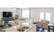 Open-concept living and dining area with a modern kitchen, comfortable seating, and ample natural light at 2159 Redfern, Dacula, GA 30019