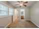 Bedroom with carpet floors, ceiling fan, and entry to a bathroom for convenience at 2245 Dauphine St, Atlanta, GA 30344