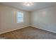 Carpeted bedroom featuring a neutral palette, and a single window offering natural light at 2245 Dauphine St, Atlanta, GA 30344
