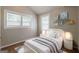 Bright bedroom featuring a bed, and two windows with coverings for ample light at 2245 Dauphine St, Atlanta, GA 30344