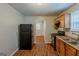 Practical kitchen with black appliances and view to another room at 2245 Dauphine St, Atlanta, GA 30344